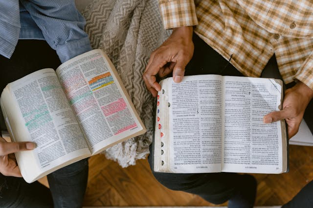 Two people reading the bible